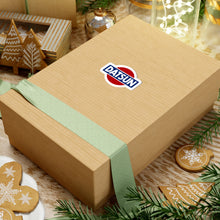 Load image into Gallery viewer, Datsun vintage logo sticker shown on a cardboard box